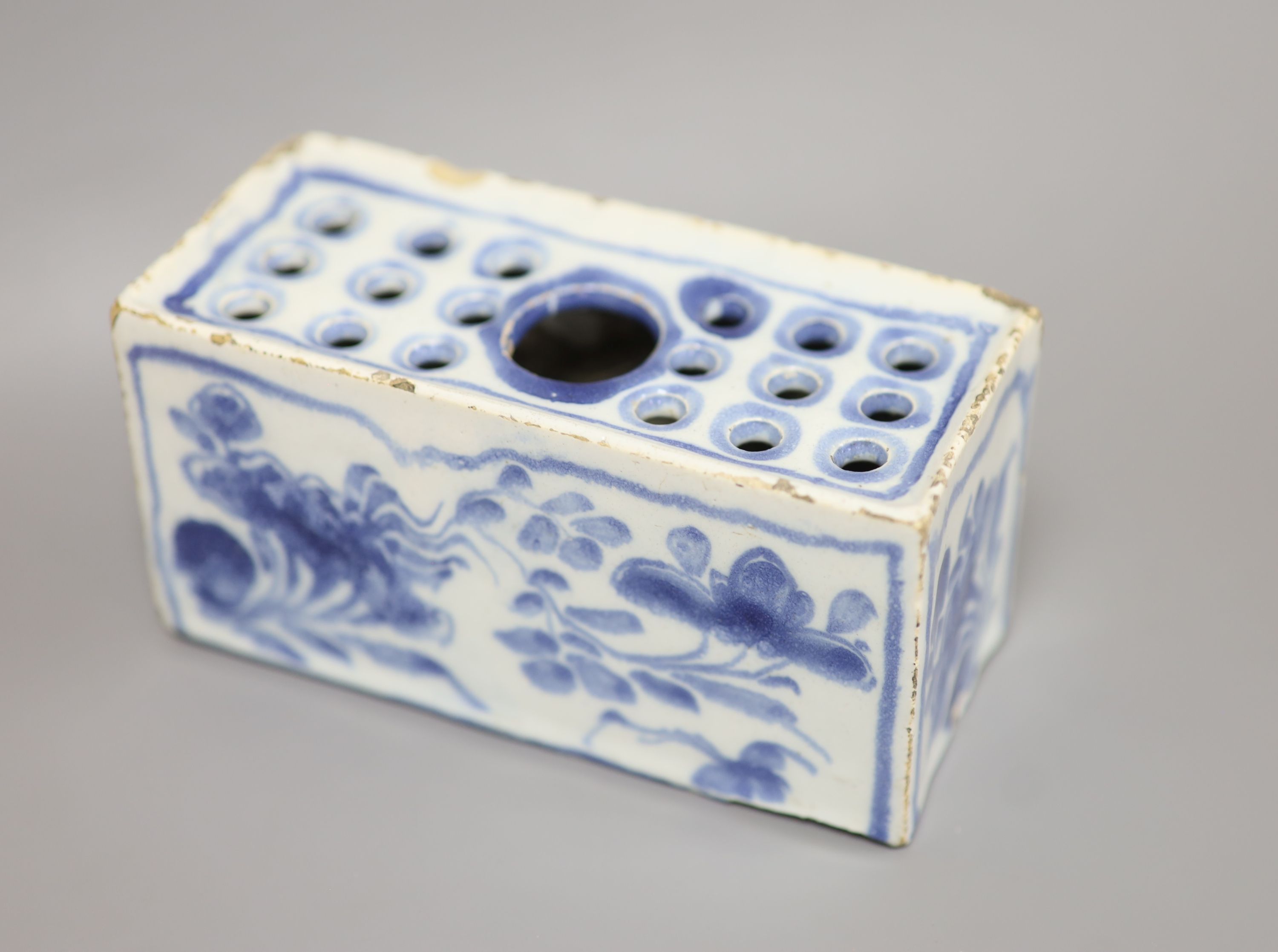 An 18th century Delft ware flower brick, length 12.5cm